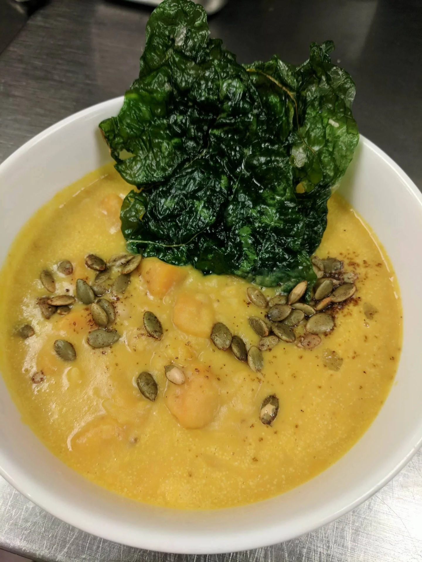 Butternut squash soup with toasted pepitas and crisped kale