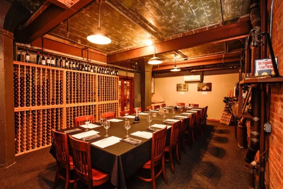 Intimate wine room table for private dinners surrounded by bottle racks